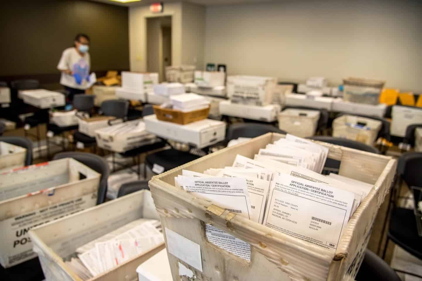 Boxes of absentee ballots are sorted by ward in a room at the madison, wis. , city county building on aug. 5, 2020, ahead of the aug. 11 election.